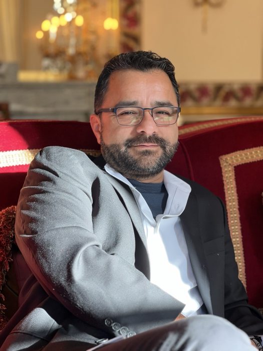 Rudy Martinez on a couch in Versailles